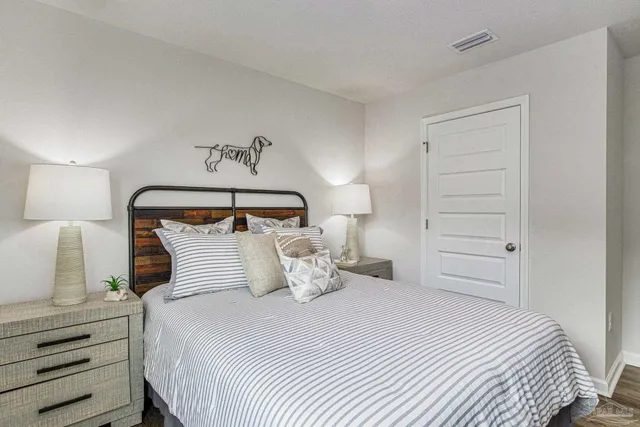 a bedroom with a bed and a night stand