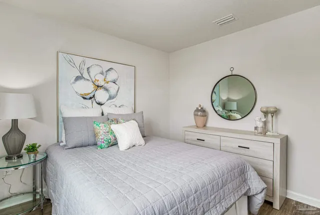 a bedroom with a bed and a mirror