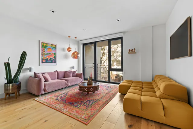 a living room with furniture rug and window