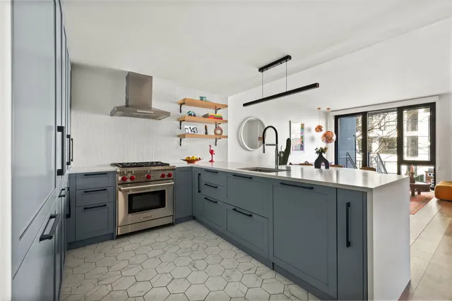 a kitchen with granite countertop a sink appliances and cabinets