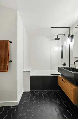 a kitchen with stainless steel appliances a sink and a refrigerator