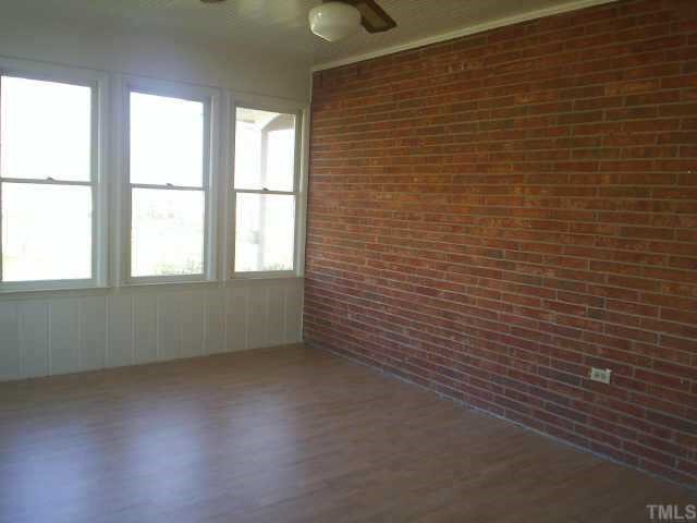 6564 Dwight Rowland Road Willow Spring, NC 27592 - Photo 4 of 6 a view of an empty room with a window