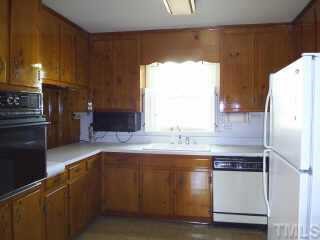 6564 Dwight Rowland Road Willow Spring, NC 27592 - Photo 6 of 6 a kitchen with a sink a refrigerator and a stove