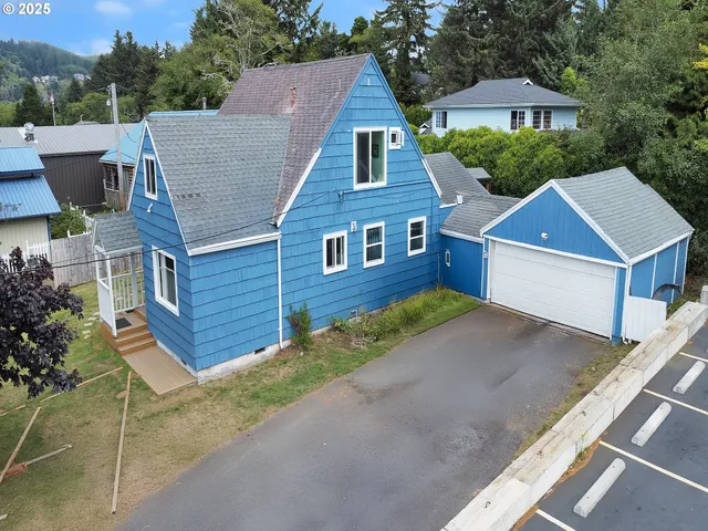 a aerial view of a house next to a yard