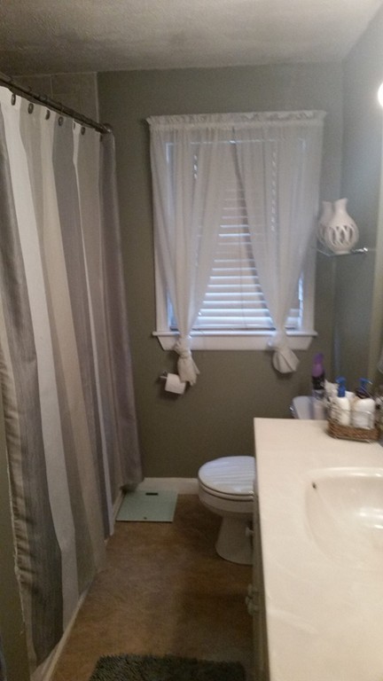 6 Anna Terrace Methuen, MA 01844 - Photo 7 of 11 a bathroom with a sink a toilet a window and vanity