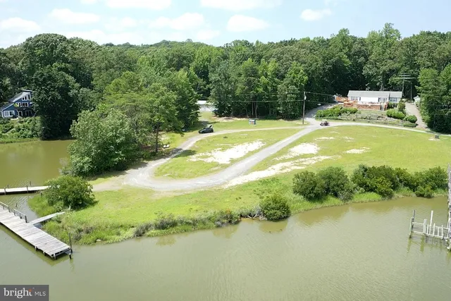 a view of a house with pool and a yard