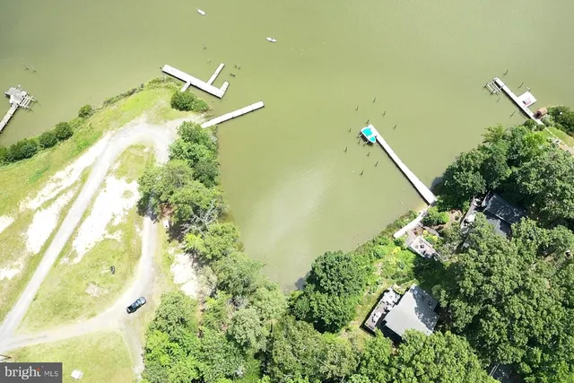 an aerial view of a houses with a lake