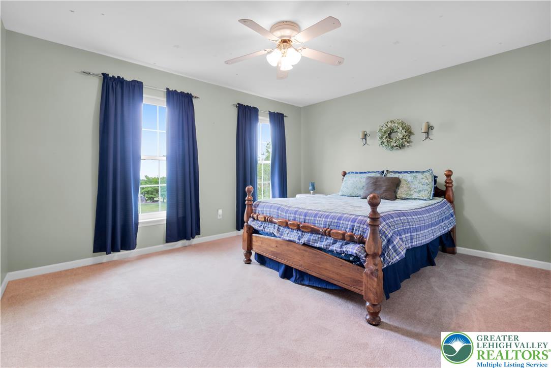 3830 McIntosh Drive Orefield, PA 18069 - Photo 20 of 36 a bedroom with a bed and a chandelier