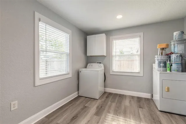 an empty room with a window and wooden floor