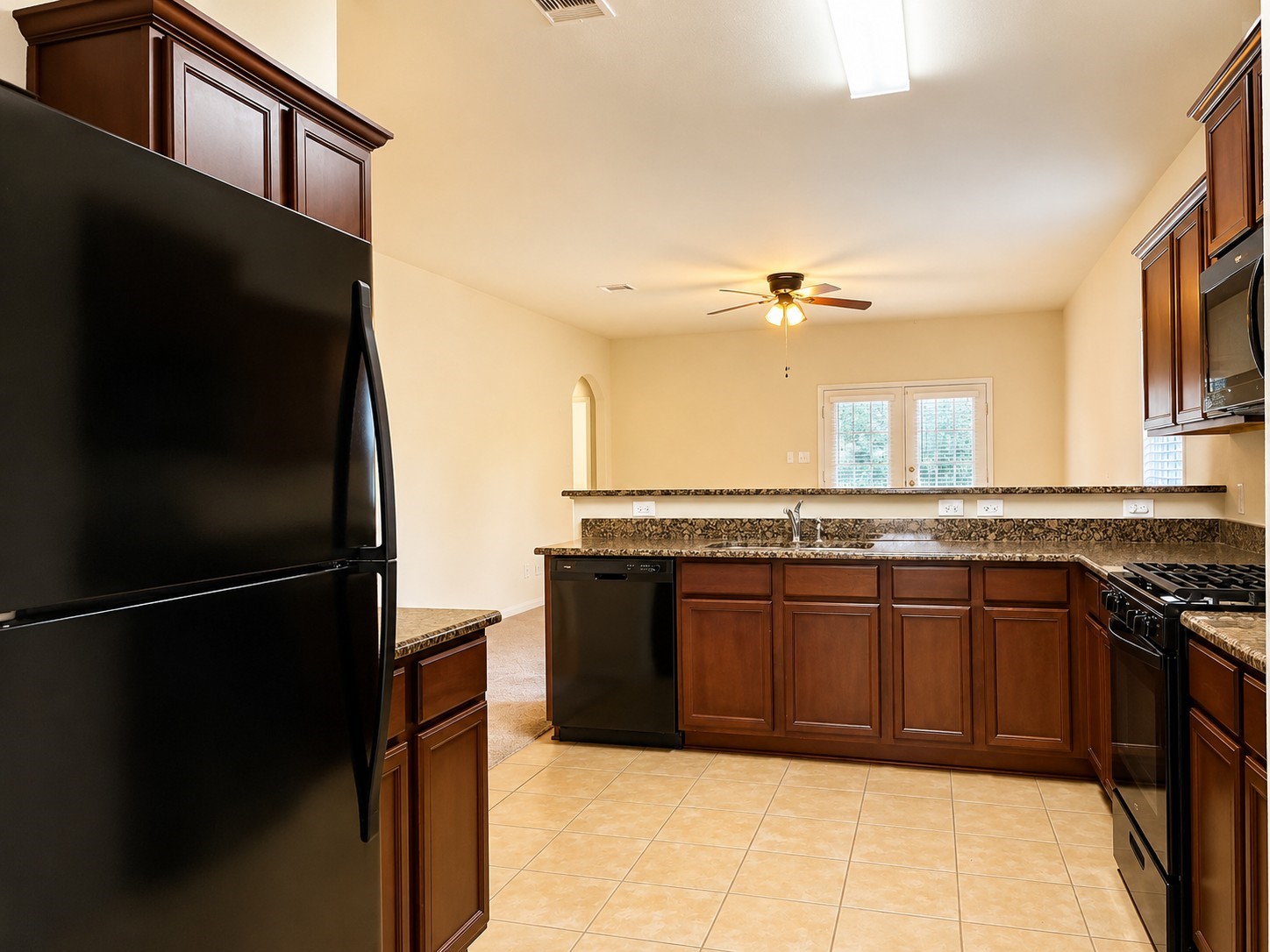 7599 Fettle Lane Conroe, TX 77304 - Photo 4 of 15 a kitchen with a refrigerator and a sink