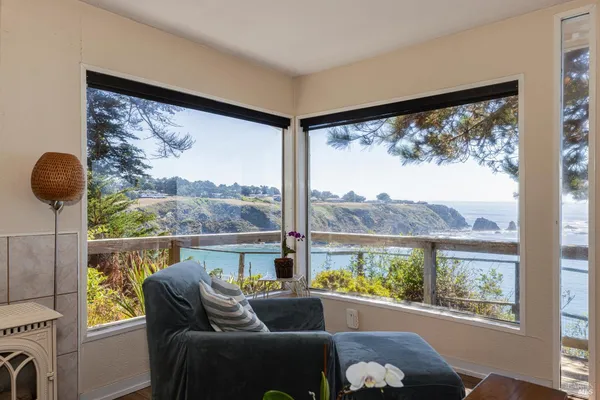 a view of a glass door with a balcony from a room