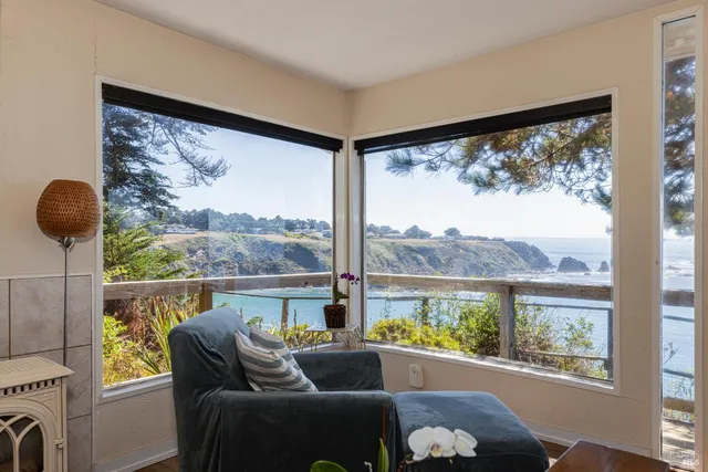 a view of a glass door with a balcony from a room