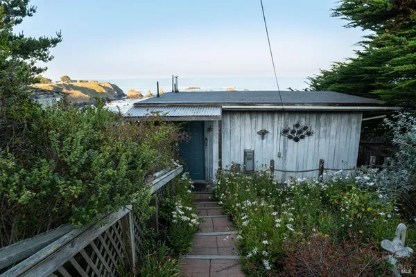 a bedroom with a bed and a dresser next to a window