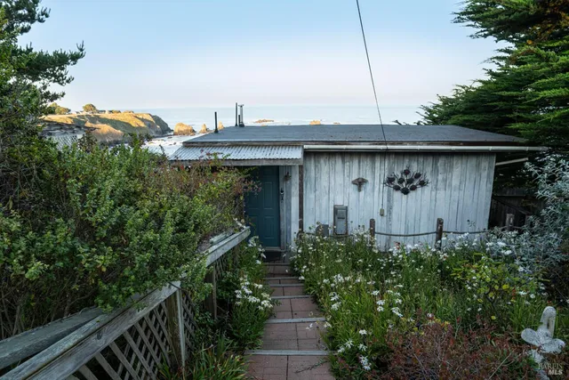 a bedroom with a bed and a dresser next to a window