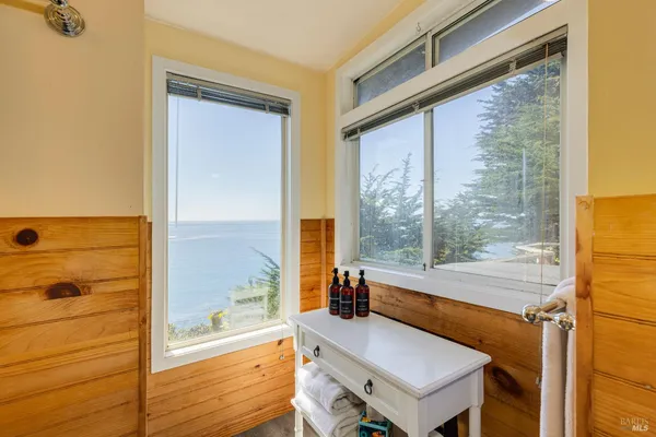 a spacious bedroom with a bed and a view of bathroom