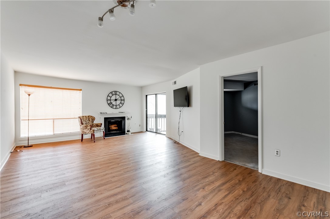 10292 Iron Mill Road North Chesterfield, VA 23235 - Photo 11 of 24 an empty room with wooden floor and fireplace