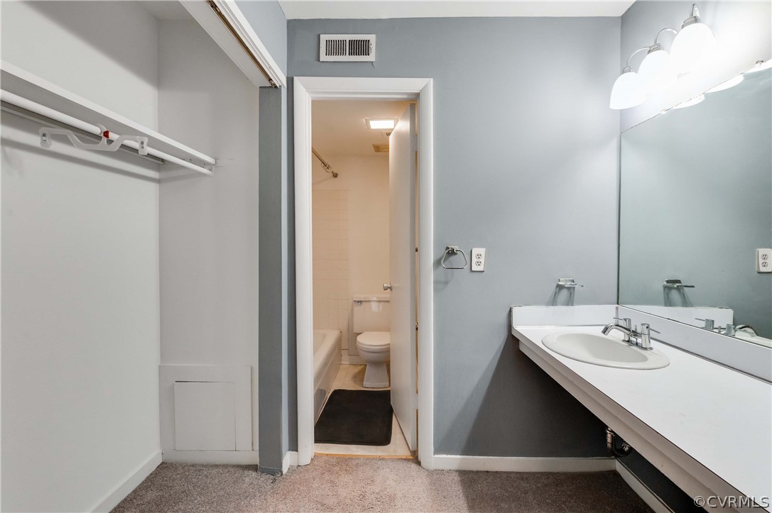 10292 Iron Mill Road North Chesterfield, VA 23235 - Photo 19 of 24 a en suite bathroom with a sink a toilet and a mirror