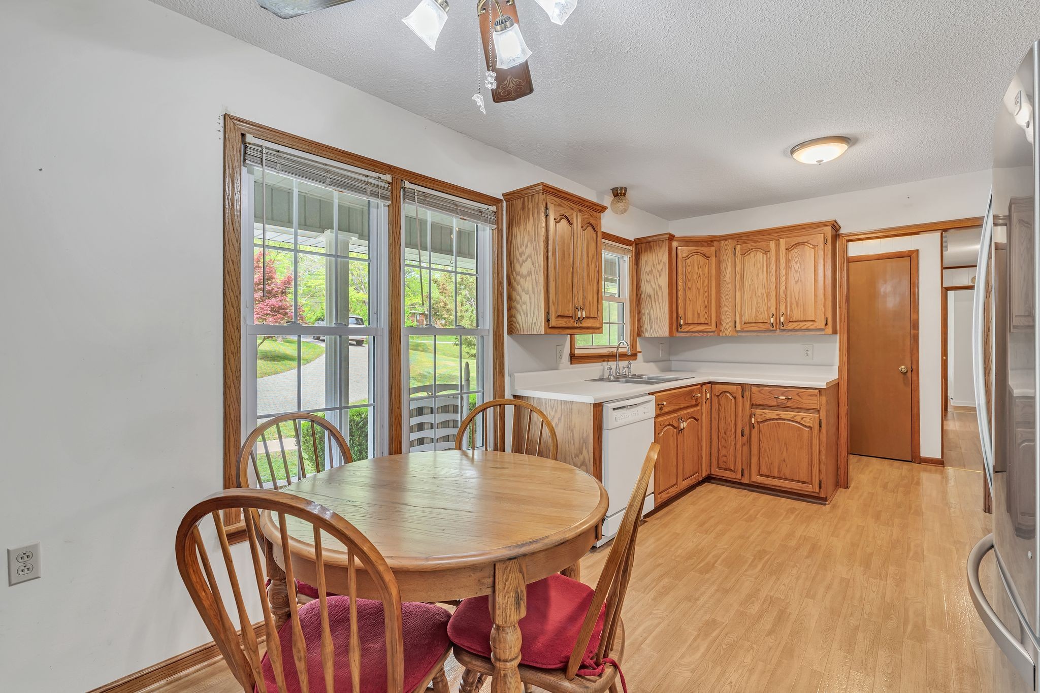 922 Hayes Road Lawrenceburg, TN 38464 - Photo 13 of 36 a kitchen with stainless steel appliances granite countertop a stove a refrigerator a dining table and chairs with wooden floor