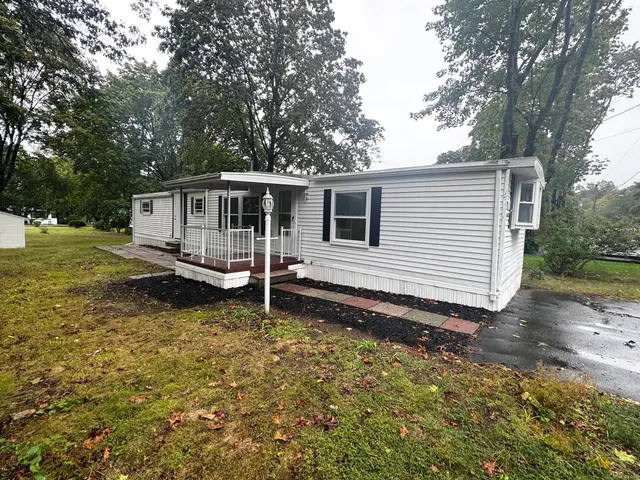 a backyard of a house with yard table and chairs