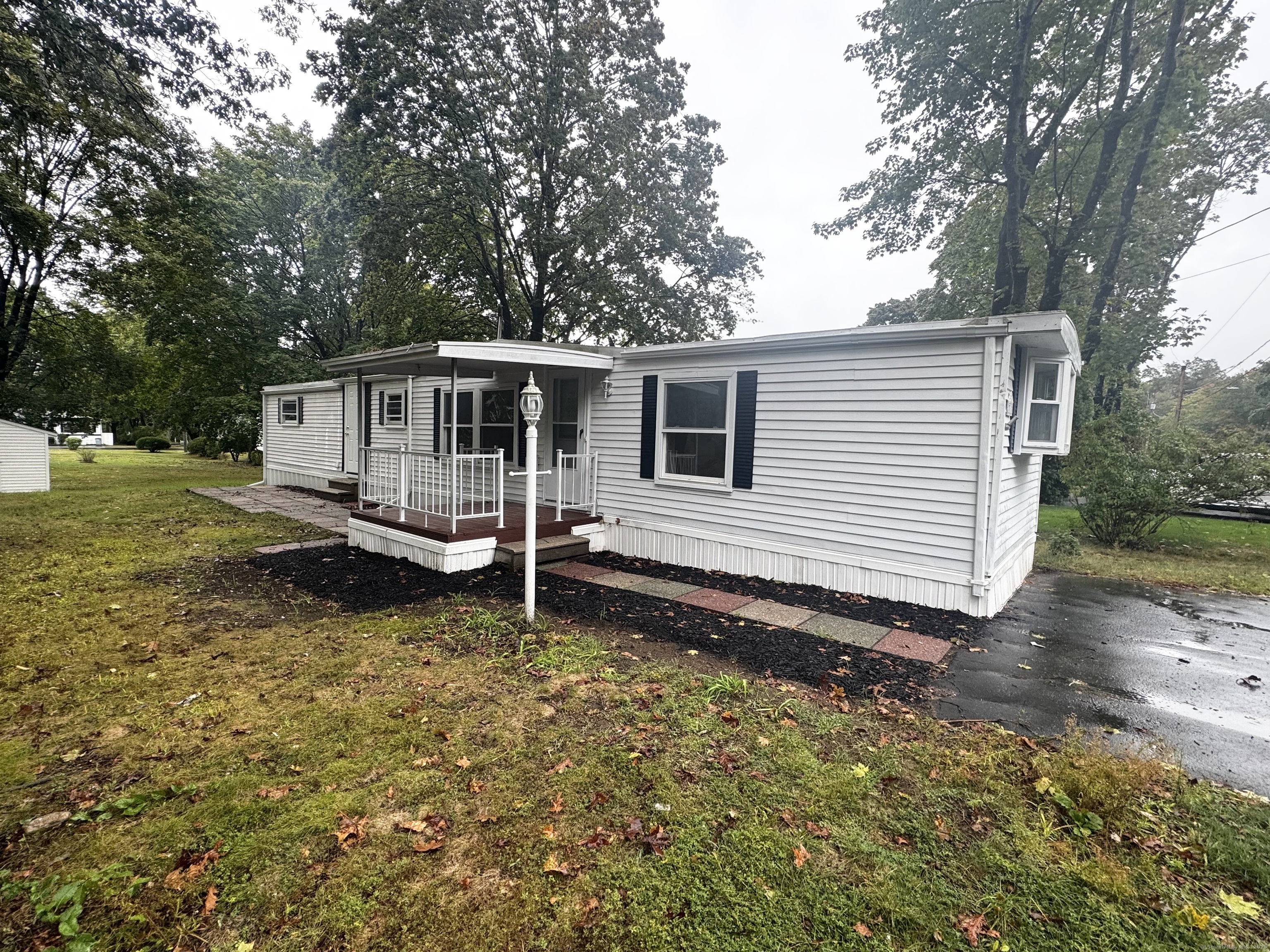 33 Whitewood Road Killingworth, CT 06419 - Photo 1 of 8 a backyard of a house with yard table and chairs