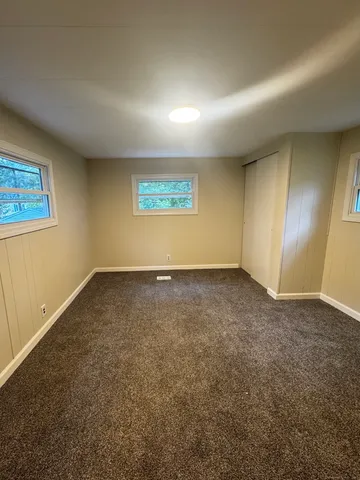 an empty room with a empty space and windows