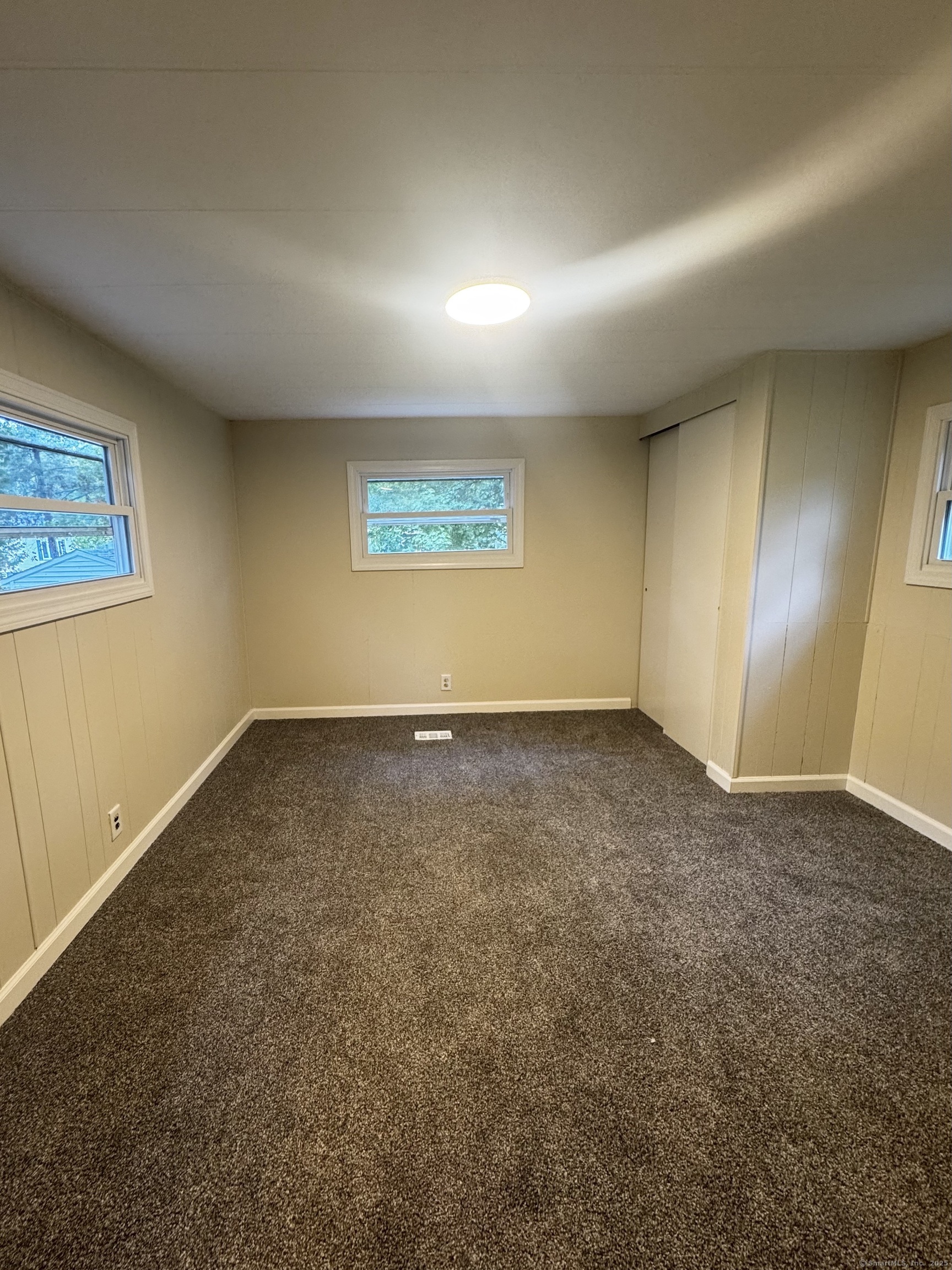 33 Whitewood Road Killingworth, CT 06419 - Photo 6 of 8 an empty room with a empty space and windows