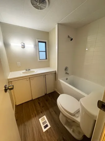 a bathroom with a toilet a sink and bathtub