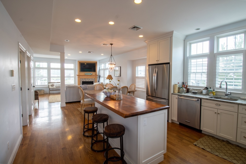 117 River Street Scituate, MA 02050 - Photo 6 of 23 a kitchen with sink cabinets and wooden floor