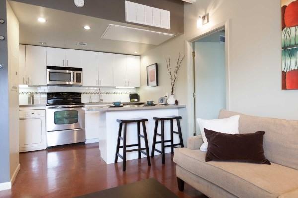 2408 Leon Street, Unit 202 Austin, TX 78705 - Photo 2 of 7 a kitchen with a table chairs microwave and cabinets