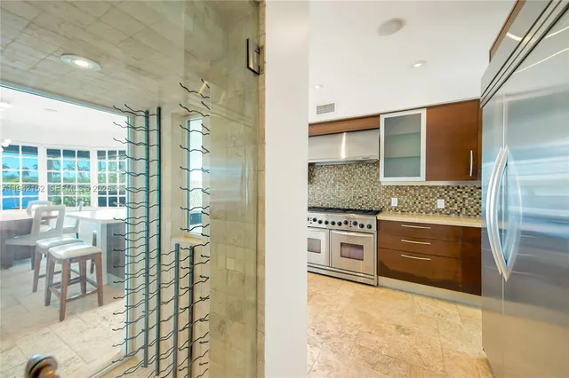 a kitchen with stainless steel appliances granite countertop a stove and white cabinets