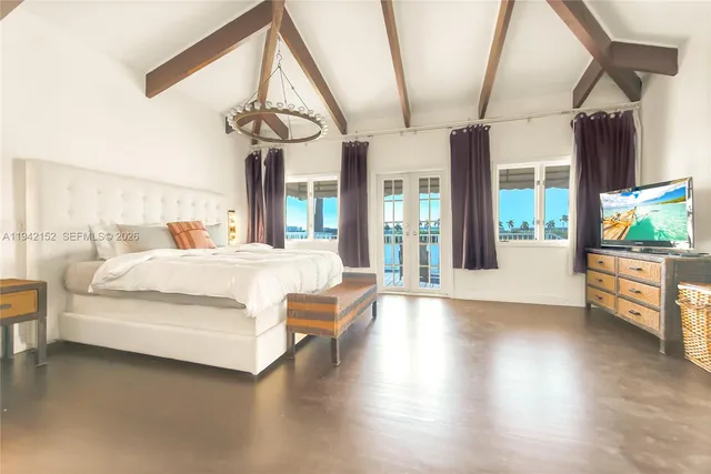 a bedroom with furniture and large window