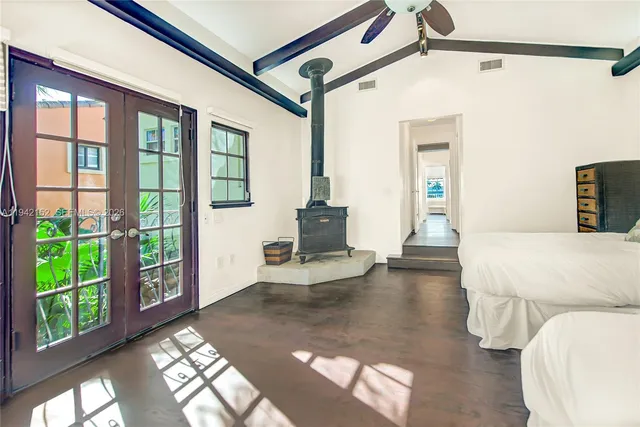 a spacious bedroom with two beds and a window