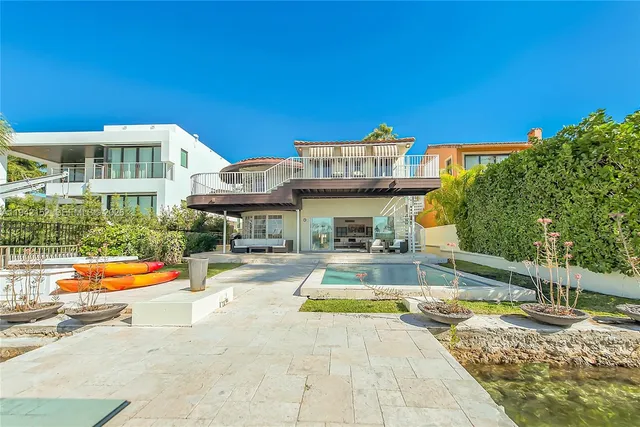 an aerial view of a house with a yard swimming pool and outdoor seating