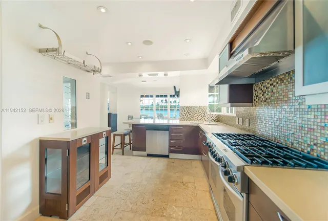 a kitchen with lots of counter top space and stove