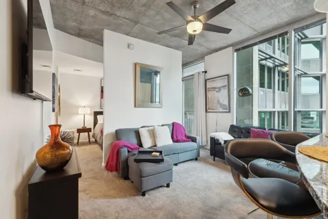 a living room with furniture and a large window