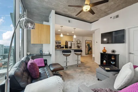 a living room with furniture and a flat screen tv