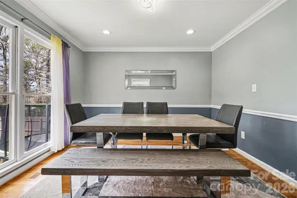 a living room with furniture a rug and a large window