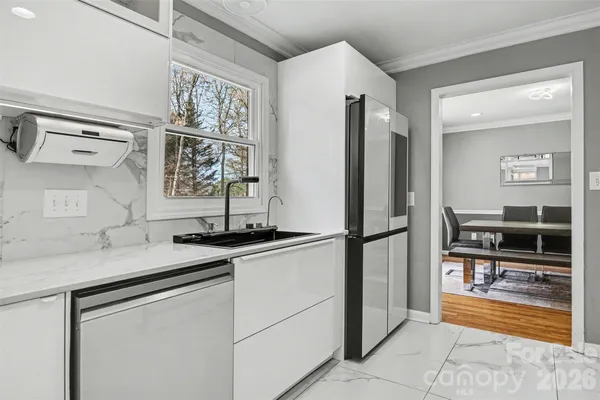 a kitchen with stainless steel appliances granite countertop a refrigerator and a sink
