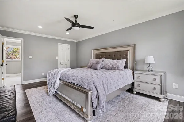 a spacious bedroom with a bed and a chandelier
