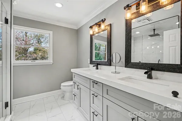 a bathroom with a toilet sink and mirror