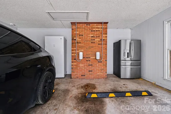 a kitchen with stainless steel appliances granite countertop a refrigerator and a stove