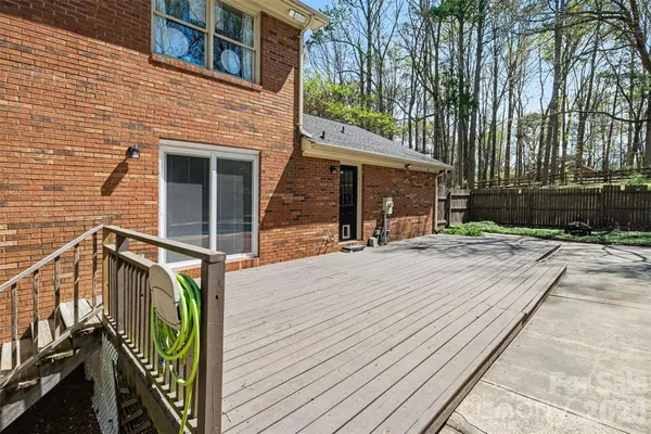 a view of a house with a wooden deck