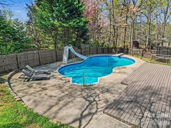 a view of a backyard with swimming pool