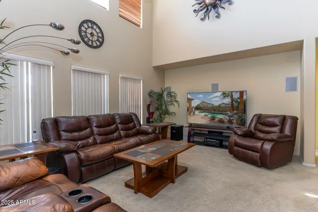 a living room with furniture a clock and a window