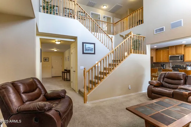 a livingroom with furniture and stairs