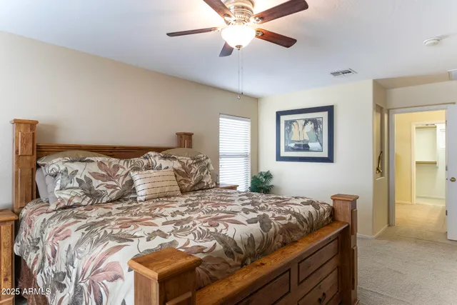 a bedroom with a large bed and a chandelier