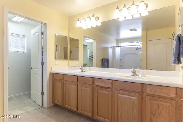 a bathroom with a double vanity sink and a mirror