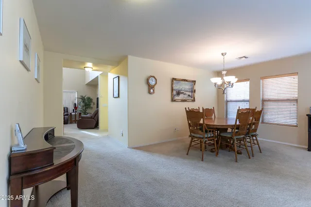 a view of a dining room with furniture and window