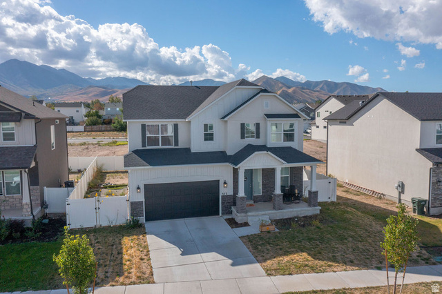 373 Quartz Road Tooele, UT 84074 - Photo 1 of 38 Two-story residence with a covered front porch, attached two-car garage, and a dark asphalt shingle roof