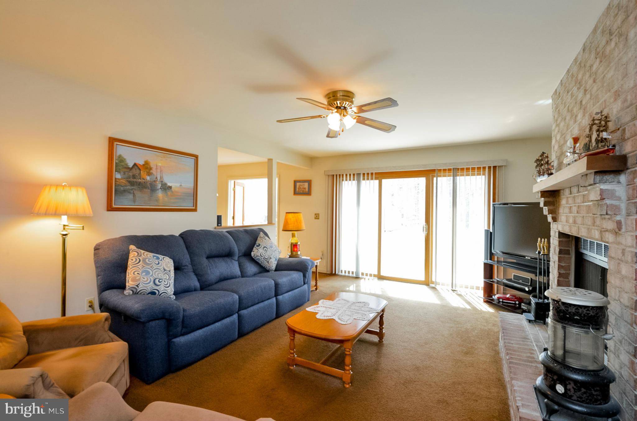 575 Pasture Brook Road Severn, MD 21144 - Photo 12 of 29 a living room with furniture a fireplace and a flat screen tv